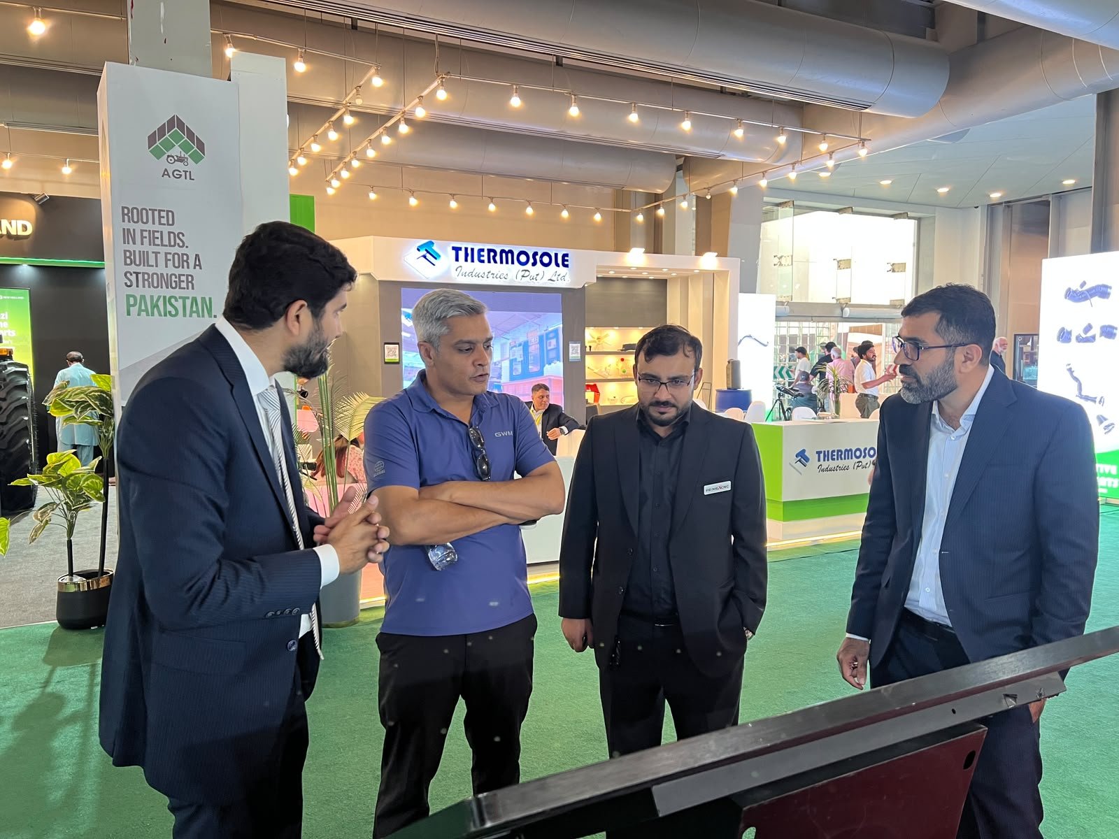 PrimeX CNC representatives discussing technology with visitors