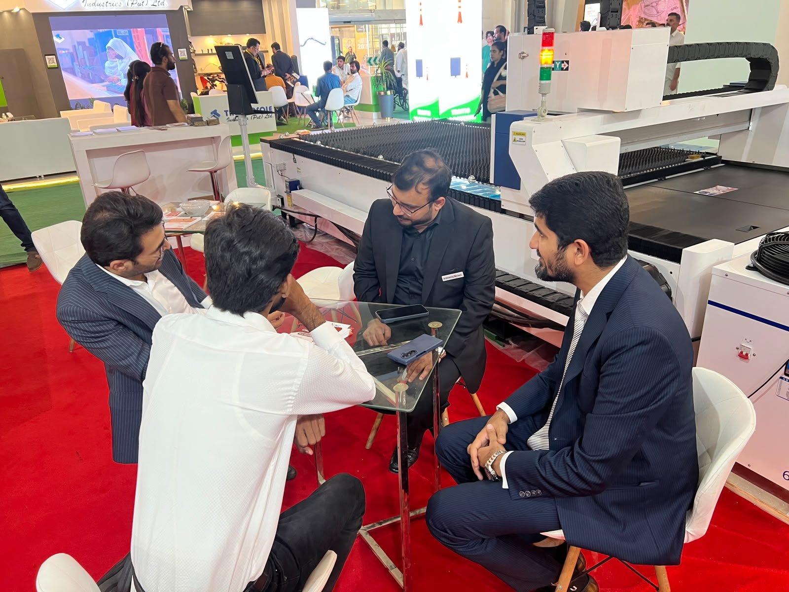 Business discussion around industrial equipment at an exhibition