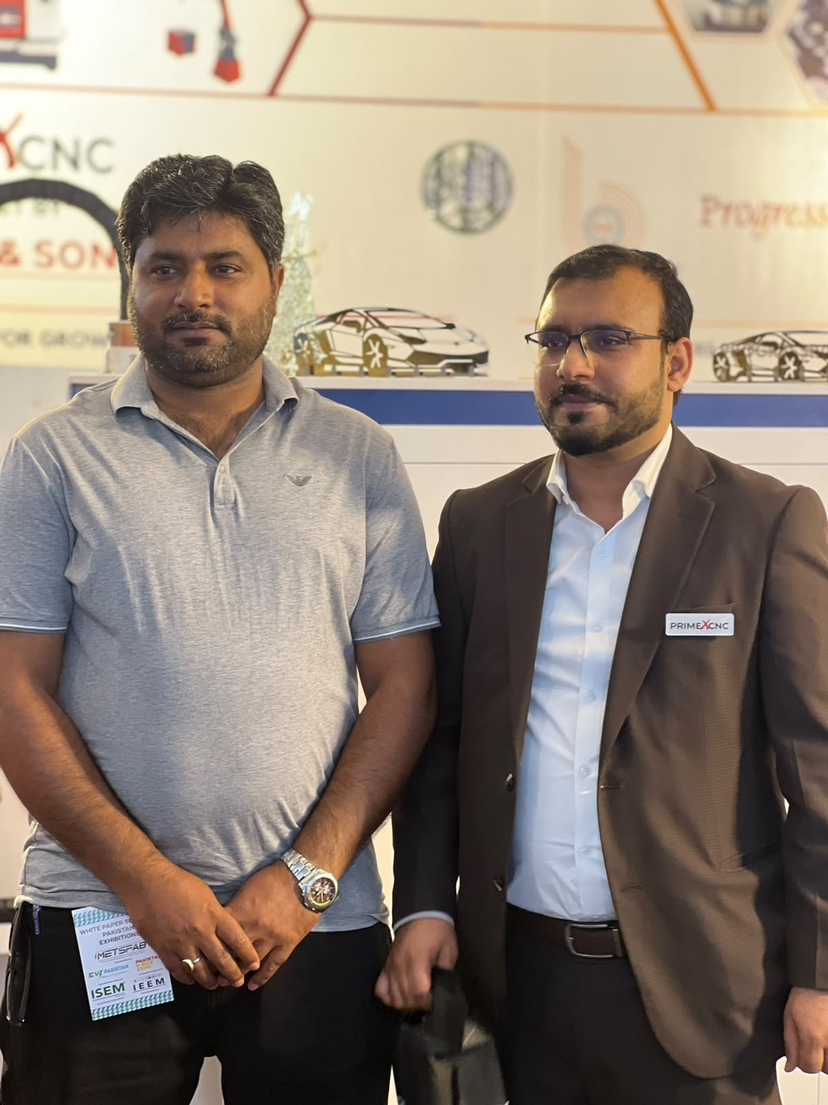 PrimeX CNC representatives meeting at an industry event